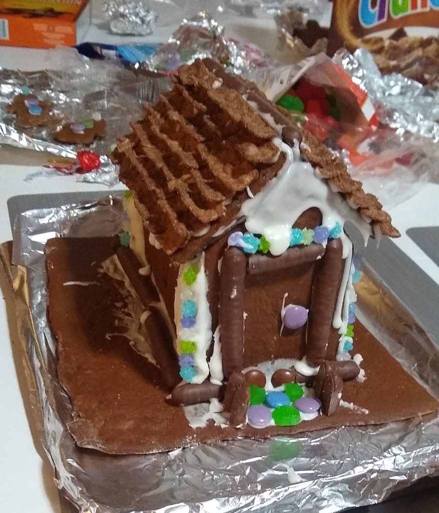 close-up of gingerbread house with shingled roof made of cereal